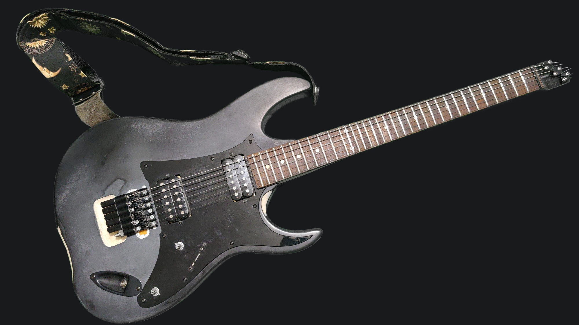 a 6 string electric guitar with microtonal frets and headless hardware